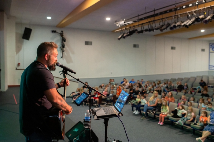 Award-winning singer/songwriter Jared Campbell performs positive and encouraging rock songs for an auditorium full of Sandy Creek Elementary students.