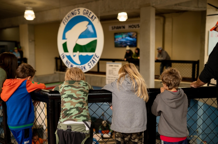 Second graders from Sandy Creek Elementary School witness the salmon egg retrieval process in the Spawn House.