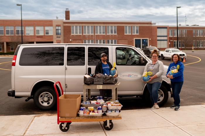 Elias Ramon Acevedo and Jessica Barnes, both from Connextcare, donated and delivered Thanksgiving meals to Backpack Project’s Buffy Peterson at the Sandy Creek Central School District.